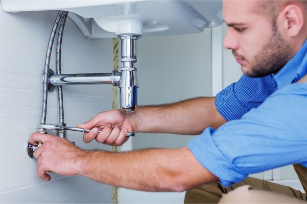 Plumber fixing sink