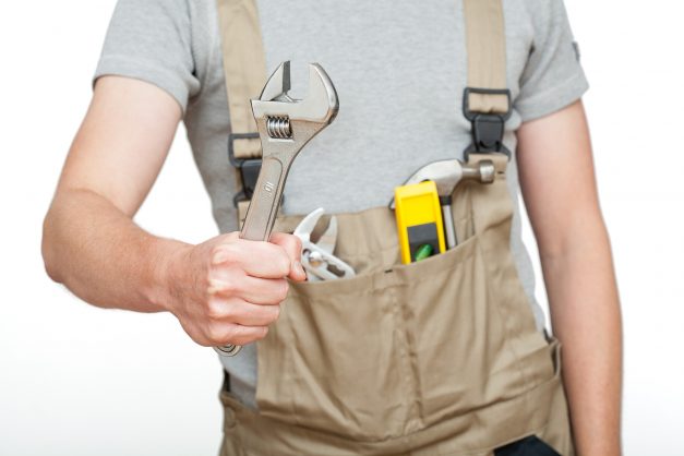 Strong Worker Holding A Spanner On White Isolated Background